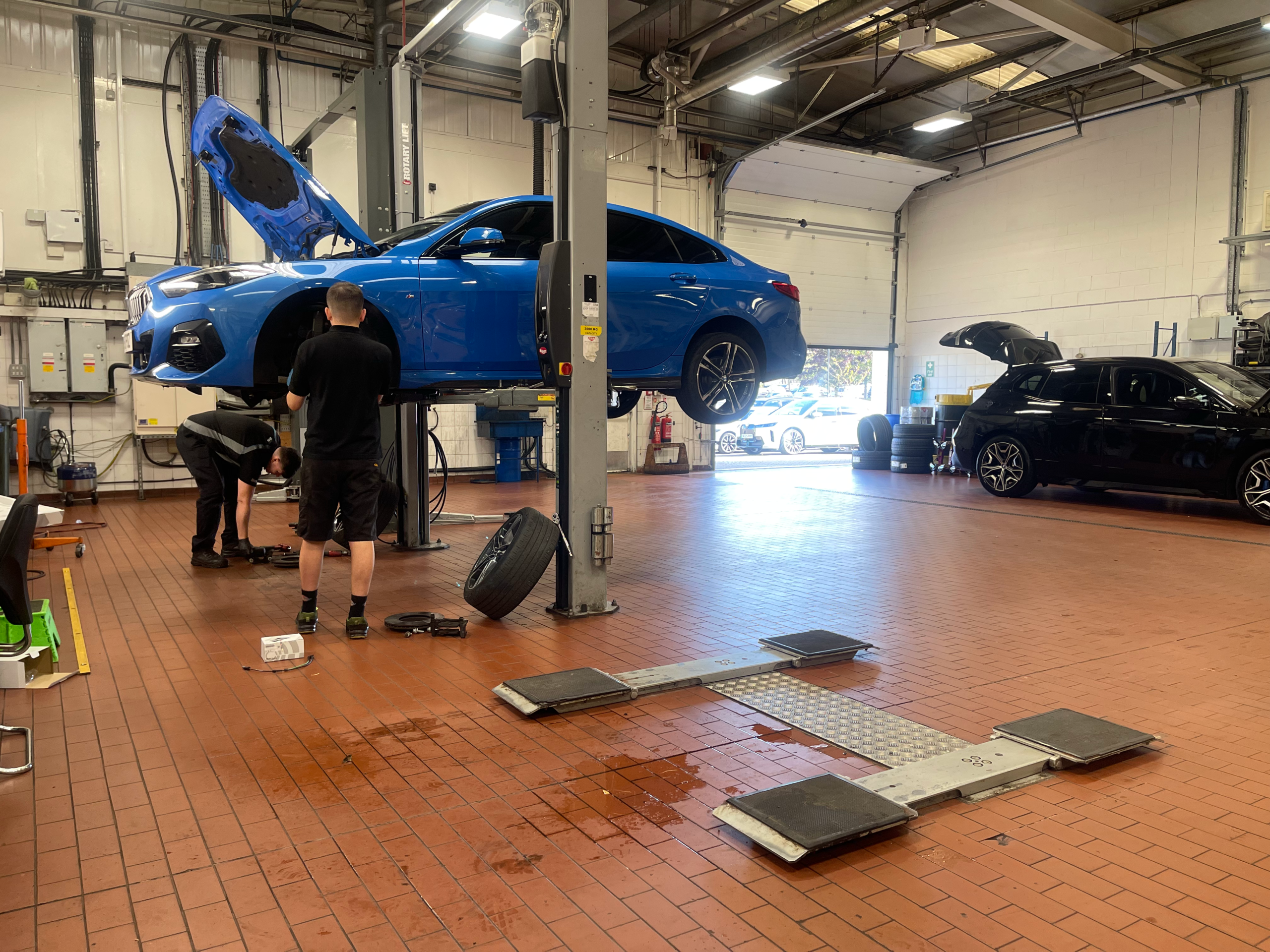 technician performing PAT testing in a BMW dealership on garage and workshop relate equipment in Newcastle